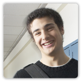 Photo of a teenage boy standing in a school hallway