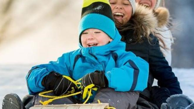 Family playing in winter snow 